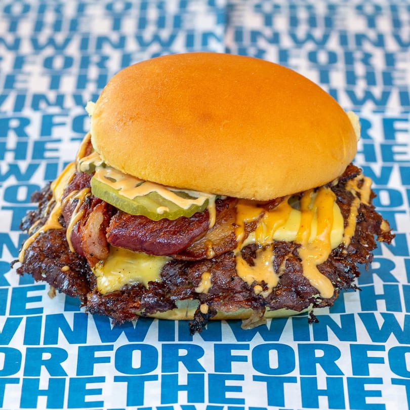Catering spread with burgers and sides
