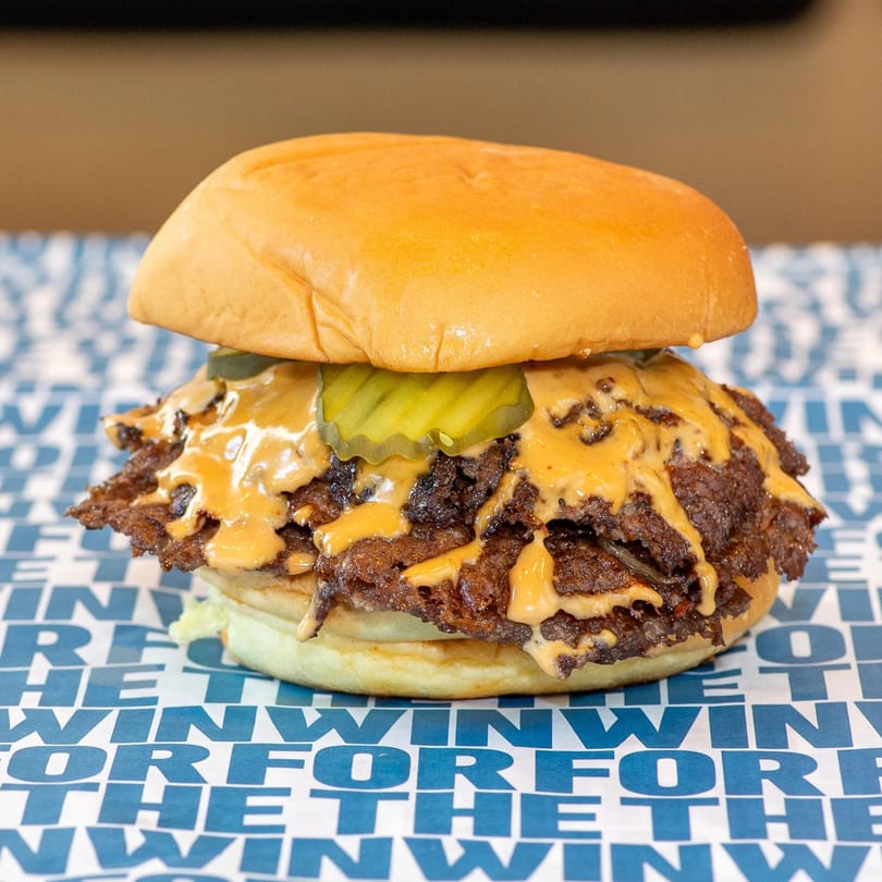 Smash burger being prepared on the griddle